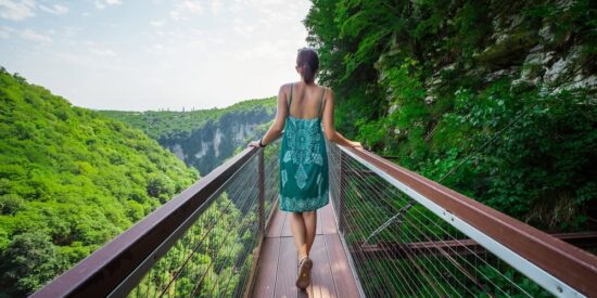 Tourist passing Okatse canyon in Georgia